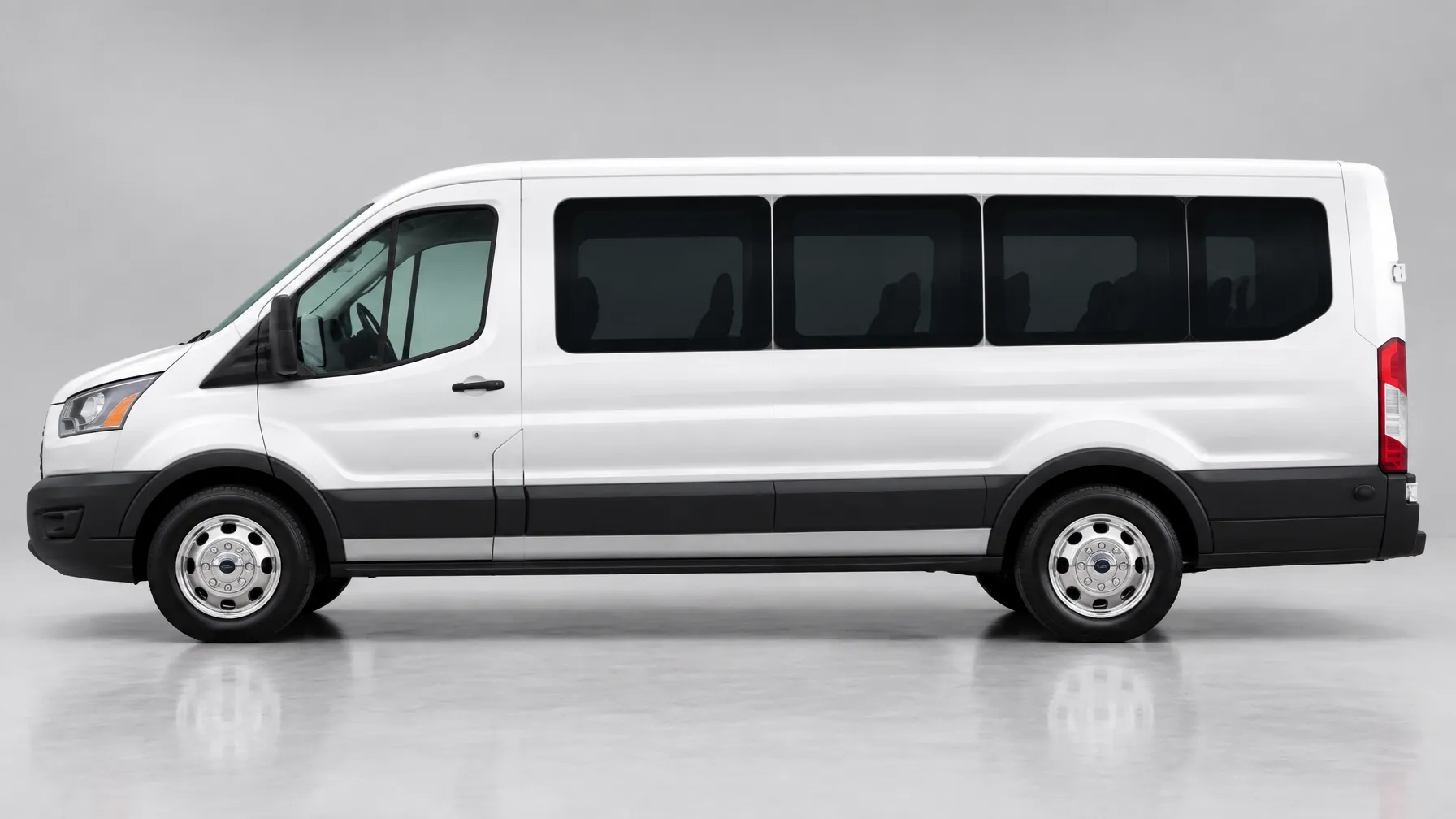 White 2023 Ford Transit 11-passenger van in side profile on a light gray studio backdrop for group rental